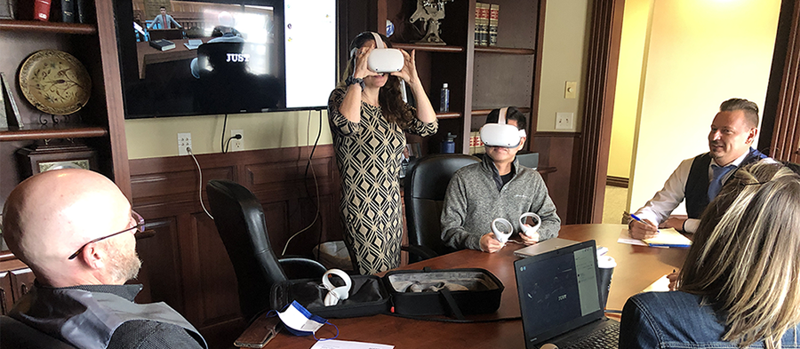 Attorneys at Smith Horras, PA wearing JUST VR headsets in their office, with a virtual courtroom simulation shown on screen behind them